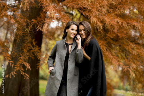 Two pretty young women usin...