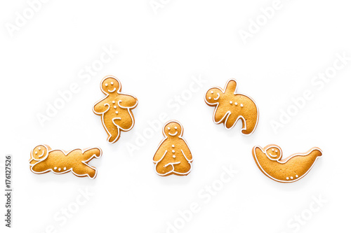 Gingerbread cookies in shape of yoga asanas on white background top view copyspace