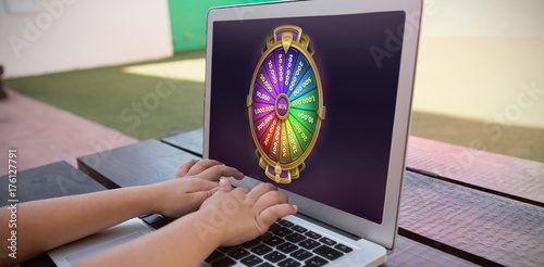 Composite image of colorful wheel of fortune on mobile screen photo