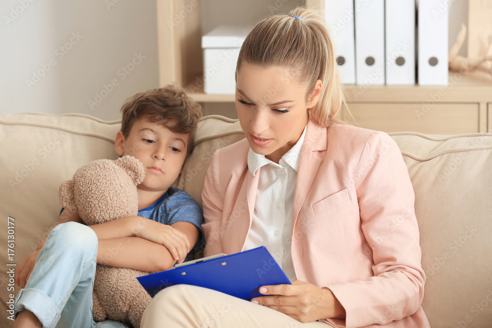 Young psychologist working with little boy in office Young psychologist working with little boy in office