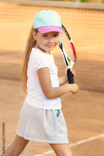 Cute little girl playing te...