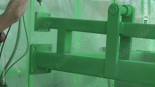 applying a green powder paint on a metal product