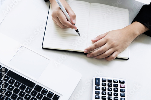 business financier audit working with laptop and calculator