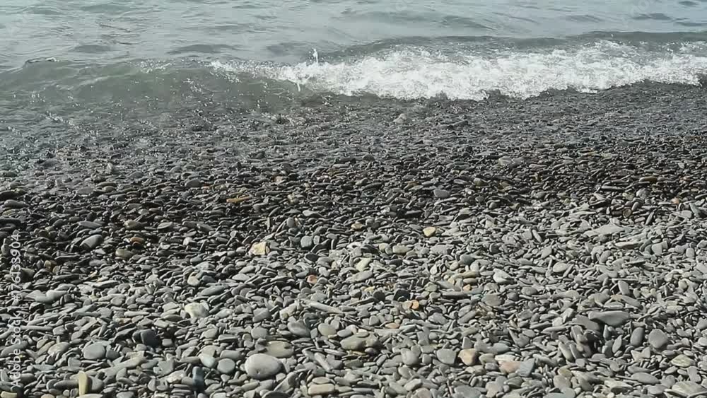 Storm surges of the sea washed the rocky beach with views of the mountains. Black Sea coast of Russia. Sea foam scatters to the winds. surf on the rocky coast. Storm surges of the sea washed the rocky beach with views of the mountains. Black Sea coast of Russia. Sea foam scatters to the winds. surf on the rocky coast.