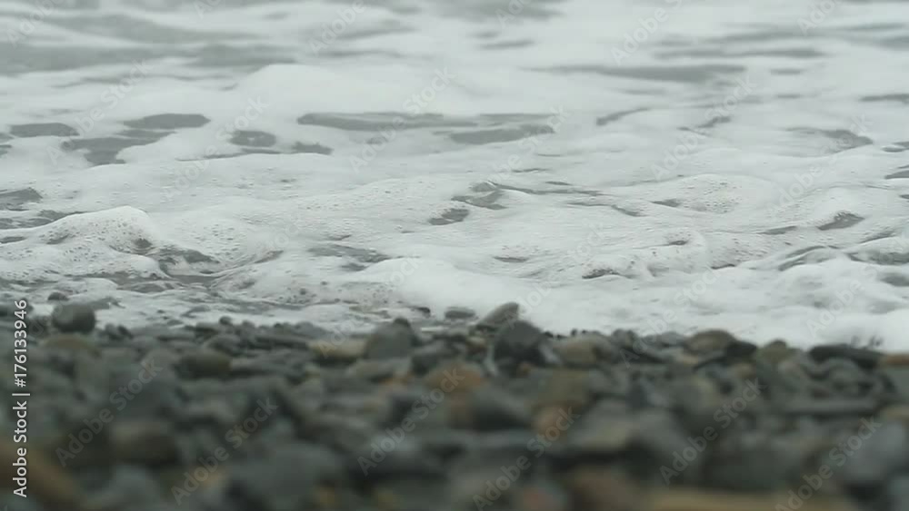 Storm surges of the sea washed the rocky beach with views of the mountains. Black Sea coast of Russia. Sea foam scatters to the winds. surf on the rocky coast. Storm surges of the sea washed the rocky beach with views of the mountains. Black Sea coast of Russia. Sea foam scatters to the winds. surf on the rocky coast.