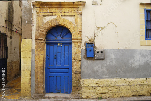 Blue wooden door on the street of medina © korinoxe