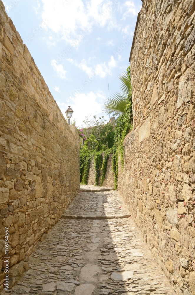 Cobblestone alley in Peratallada, Girona, Spain
