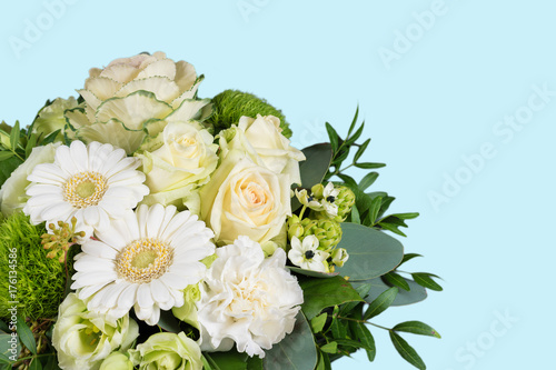 White bouquet of fresh flowers on blue background.