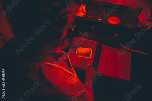 Canvas Print Man works on film black and white platinum print in laboratory.
