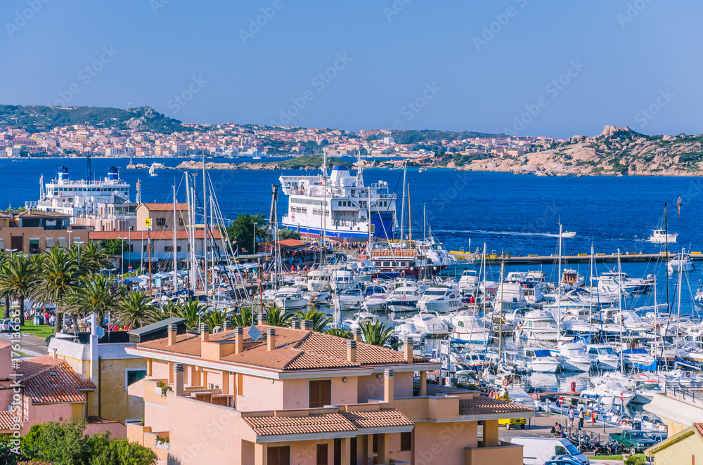 Port of Palau on sardinia island with farry and yacht boats. La Maddalena island in background