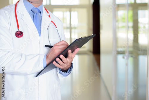 Body of doctor holding clipboard