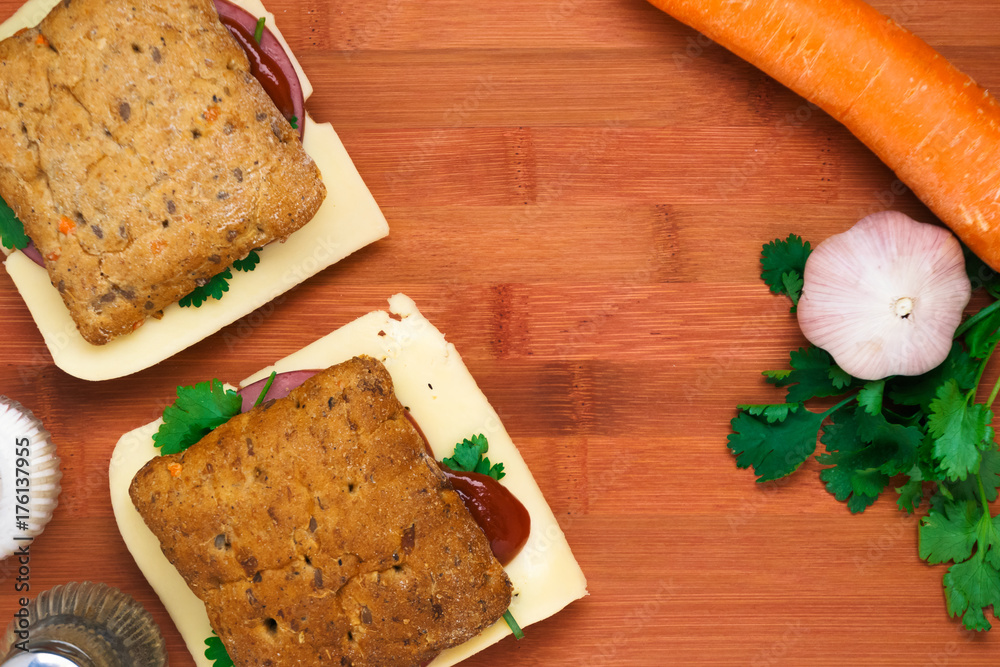 Fototapeta premium Breakfast with a sandwich with cheese and ham and vegetables