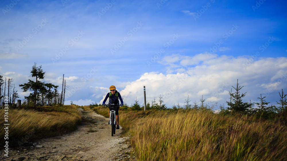Mountain biking women riding on bike in summer mountains forest landscape. Woman cycling MTB flow trail track. Outdoor sport activity. Mountain biking women riding on bike in summer mountains forest landscape. Woman cycling MTB flow trail track. Outdoor sport activity.