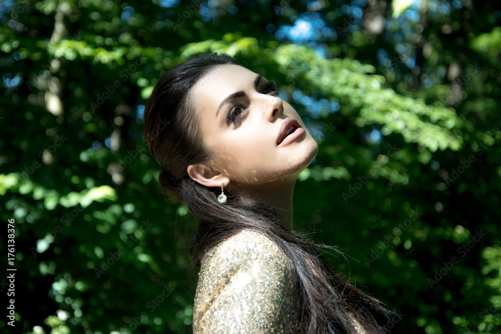 Woman or girl with brunette hair and stylish makeup