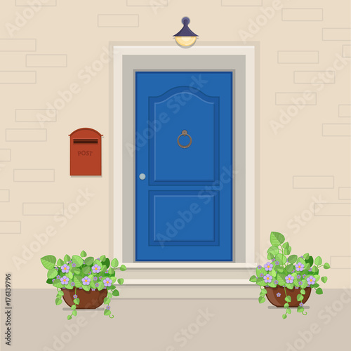 Blue front door with a mailbox on the wall and flowers in the pots