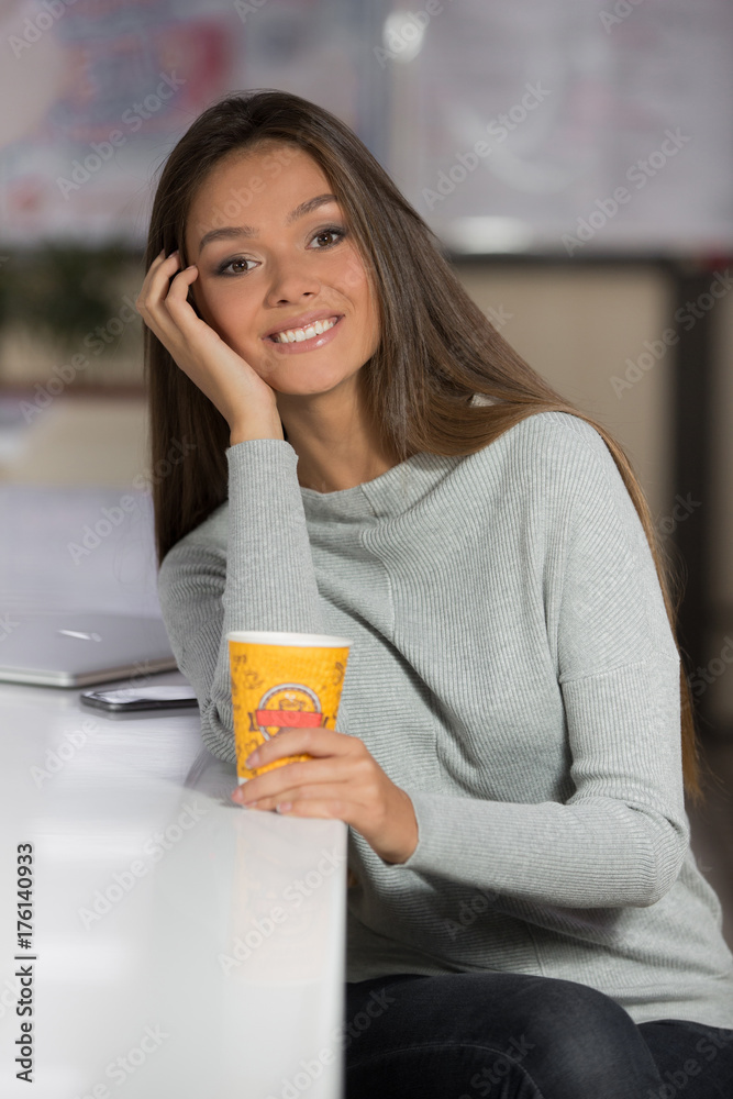 Portrait of a beautiful woman, sitting in cafe and drink coffee Portrait of a beautiful woman, sitting in cafe and drink coffee