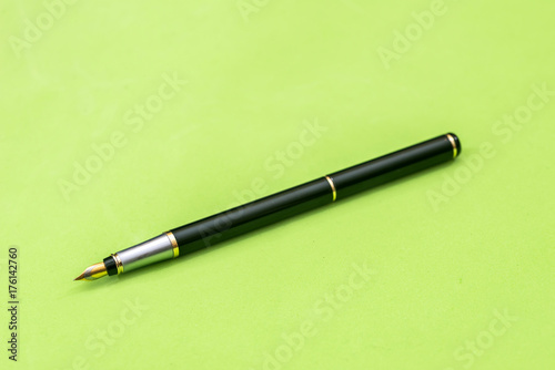 pen isolated on green background. Office equipment for paperwork.