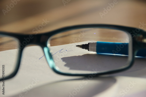 view through glasses on a pen with handwriting