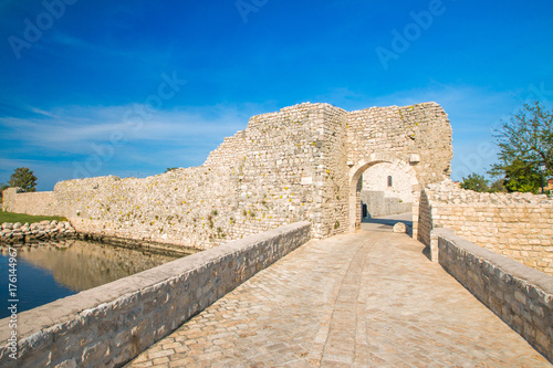 Old stone upper town gate and bridge in medieval historic town of Nin, Dalmatia, Croatia 