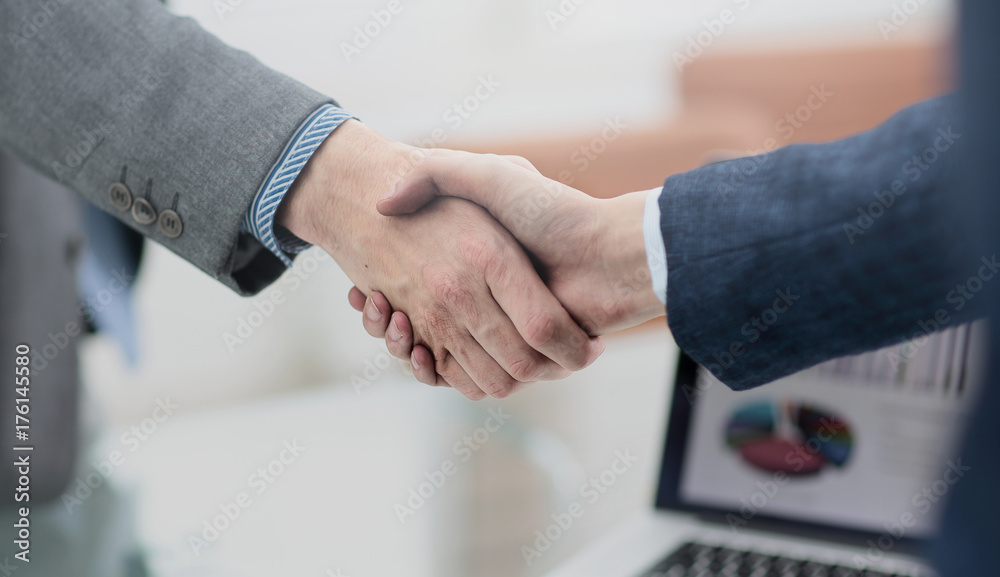 businessman shaking hands to seal a deal with his partner