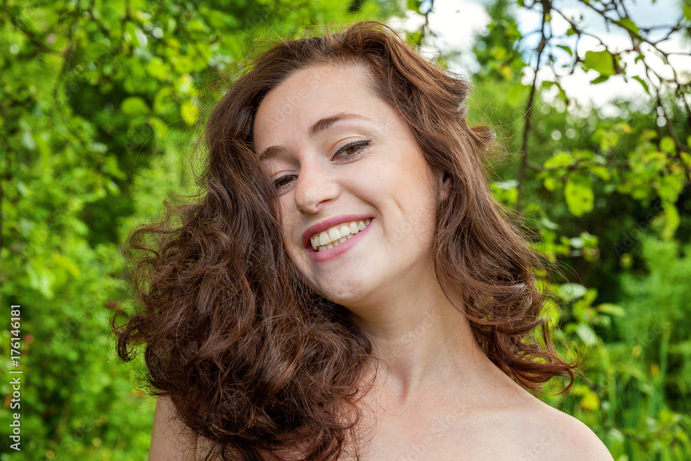 A girl is smiling at the park background A girl is smiling at the park background