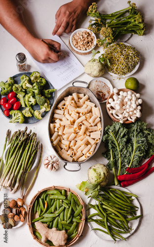 Pasta rigatoni casserole Nourishment cooking ingredients list write person hand vegan food 