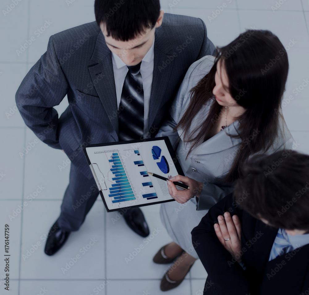Image of busiess group discussing business documents at meeting Image of busiess group discussing business documents at meeting