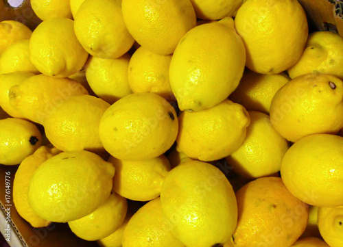 Colorful Display Lot of  Fresh yellow Lemons In Fruit Market place textures backgrounds
