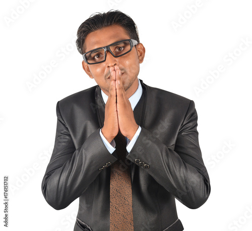 Businessman in black suit confessing over white background