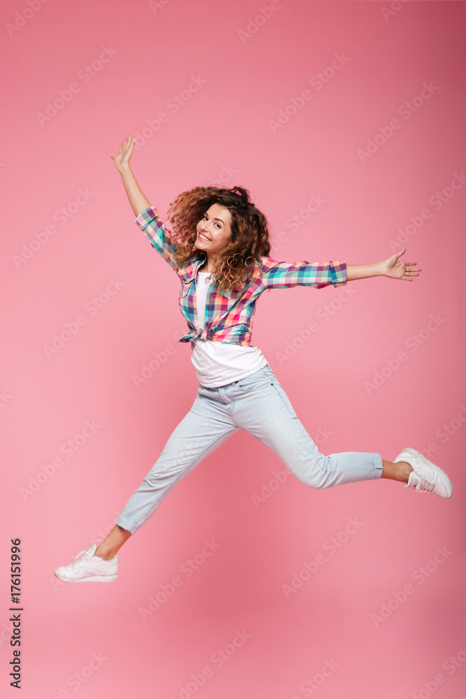 Young happy funny woman in casual clothes jumping isolated