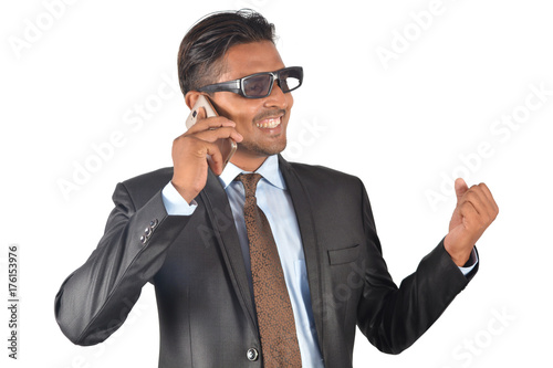 Businessman in black suit very happy on phone call over white background