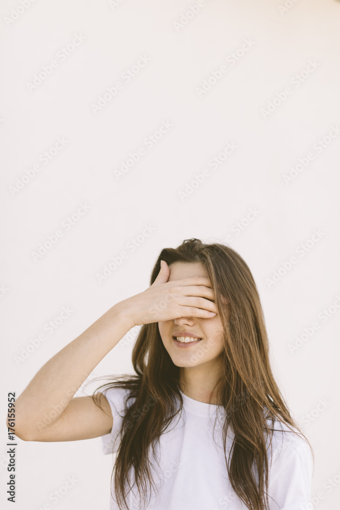 Young woman covering her face with hand Young woman covering her face with hand