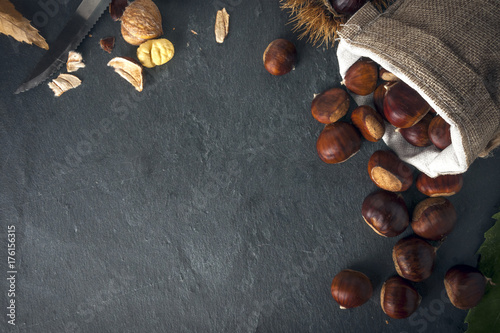 Chestnuts in jute basket on a rock table