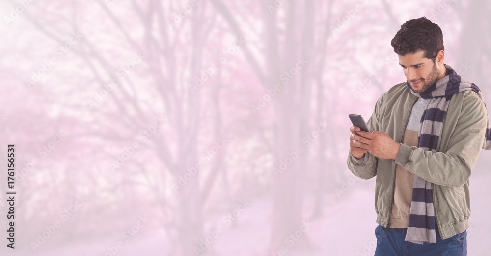 Man in Autumn with phone in bright forest Man in Autumn with phone in bright forest