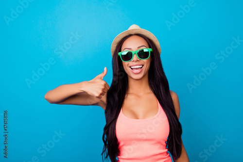 I like summer holidays, relax, rest, chill! Excited carefree gorgeous traveller in trendy shiny specs, in singlet, so hot, fit and slim, long dark hair, shows thumb  finger up, agree good sign