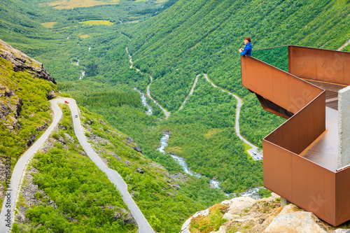 Tourist woman on Trollstigen viewpoint in Norway photo