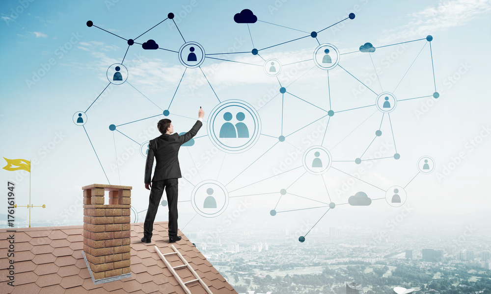 Businessman on house roof presenting networking and connection concept. Mixed media Businessman on house roof presenting networking and connection concept. Mixed media
