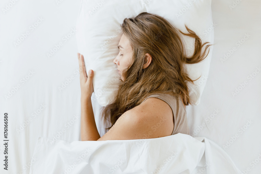 Fototapeta premium Woman is sleeping in the bed