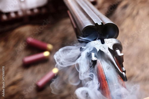 Smoke from a hunting double barrel vintage shotgun after firing.Comcept hunting.Closeup photo