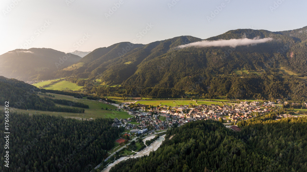 Fototapeta premium Valley opening towards a small city.