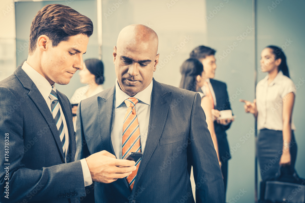 Mixed Asian and Caucasian business team meeting on terrace on front of their office Mixed Asian and Caucasian business team meeting on terrace on front of their office