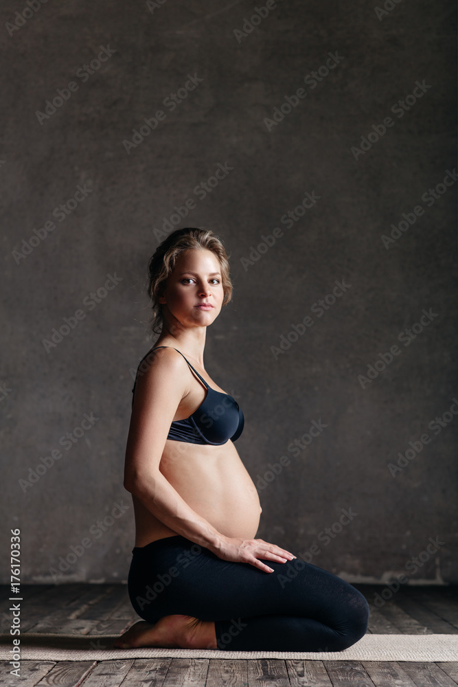 Young beautiful pregnant yoga posing in studio Young beautiful pregnant yoga posing in studio