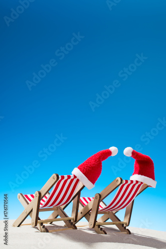 Christmas on the beach: two chairs and Santa's hats