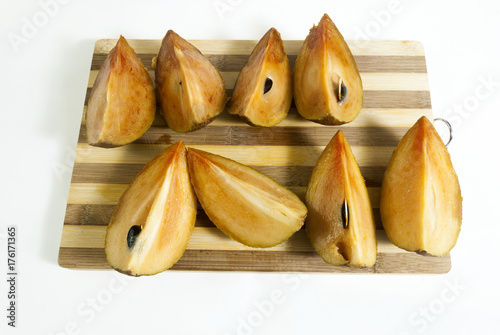 sapodilla plum with cut isolated on white. Manilkara zapota. Guatemala photo