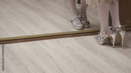 Pretty little girl wearing adult high heels