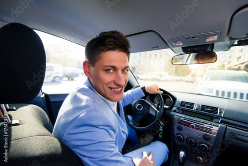 Portrait of a man in his car. Taxi driver concept. Happy automobile buyer. Test drive.