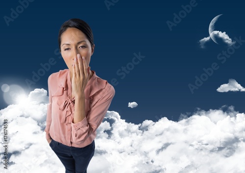 Woman yawning in clouds with moon