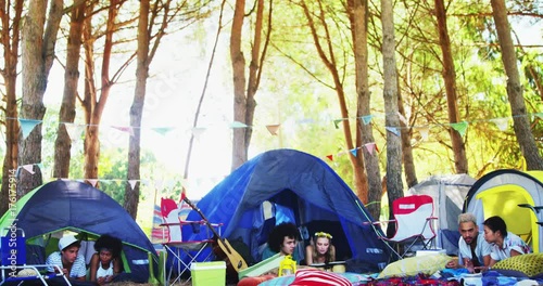 Couples relaxing on tent at music festival  photo