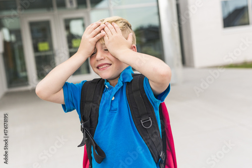 Great Portrait Of School Pupil Outside Classroom Carrying Bags photo