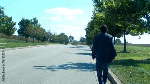 Man Walking Away on Boulevard Wearing Black Shirt Unbuttoned (Backside)